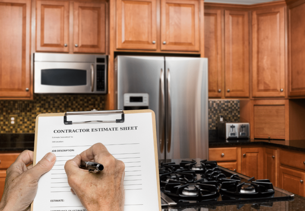 a kitchen contractor writing on an estimate sheet