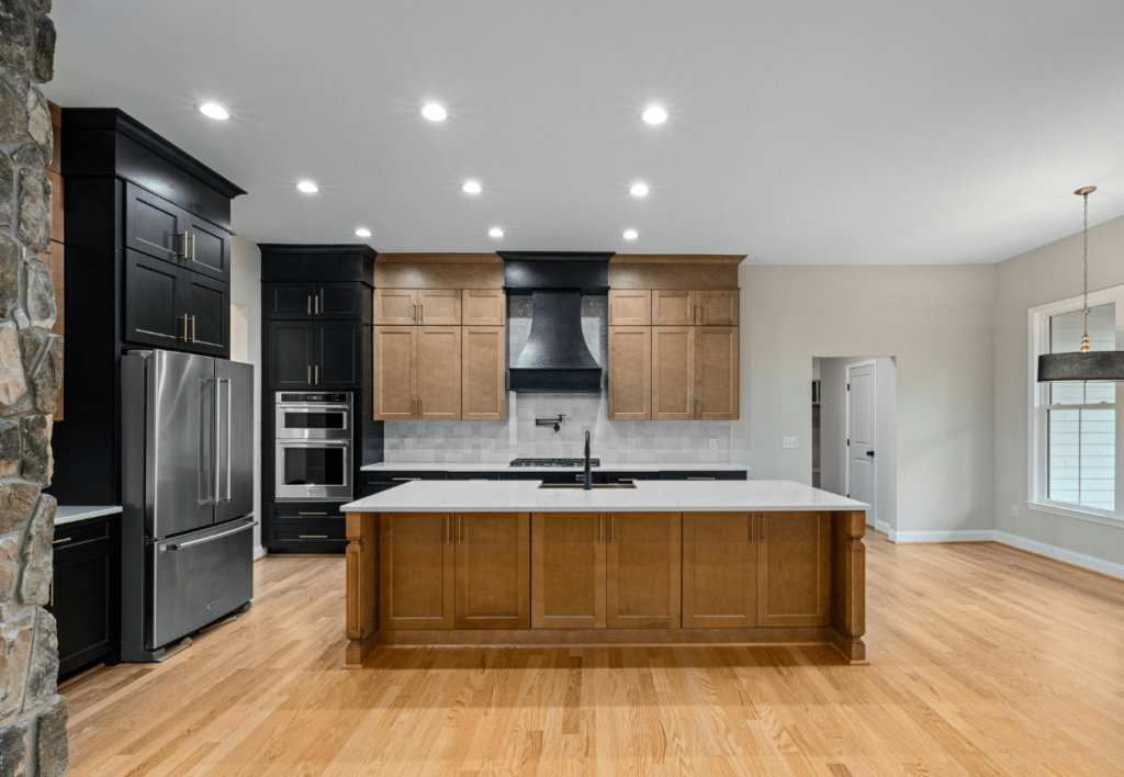 large kitchen with wood floors and granite countertops