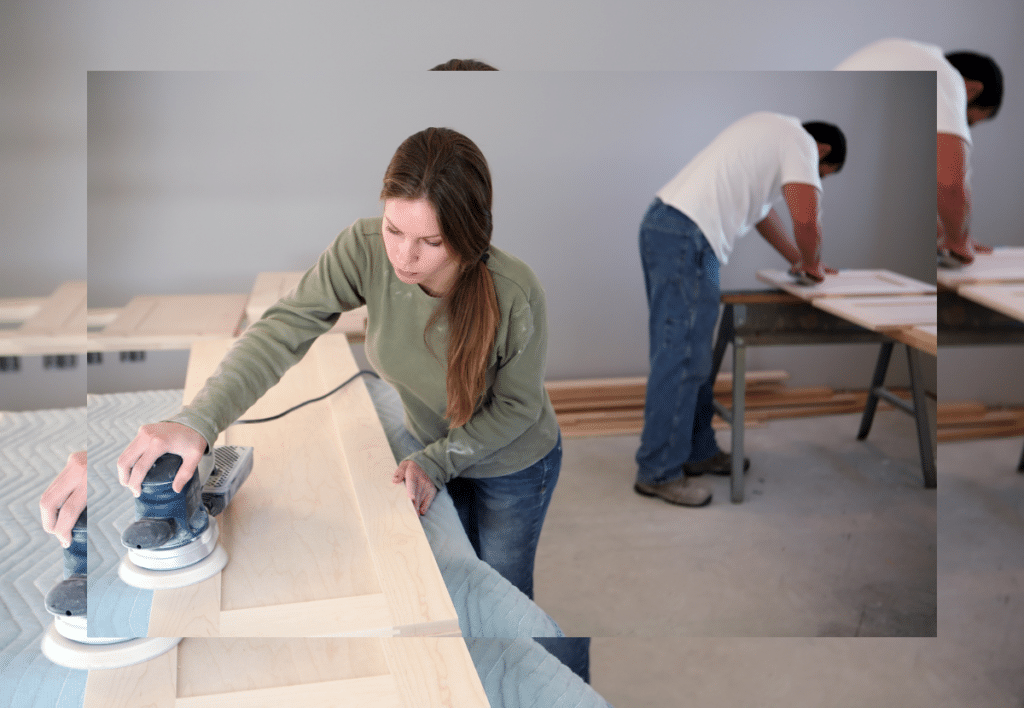 two cabinet makers using power tools for precise craftsmanship